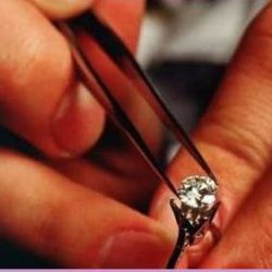 jeweller checking solitaire diamond stone